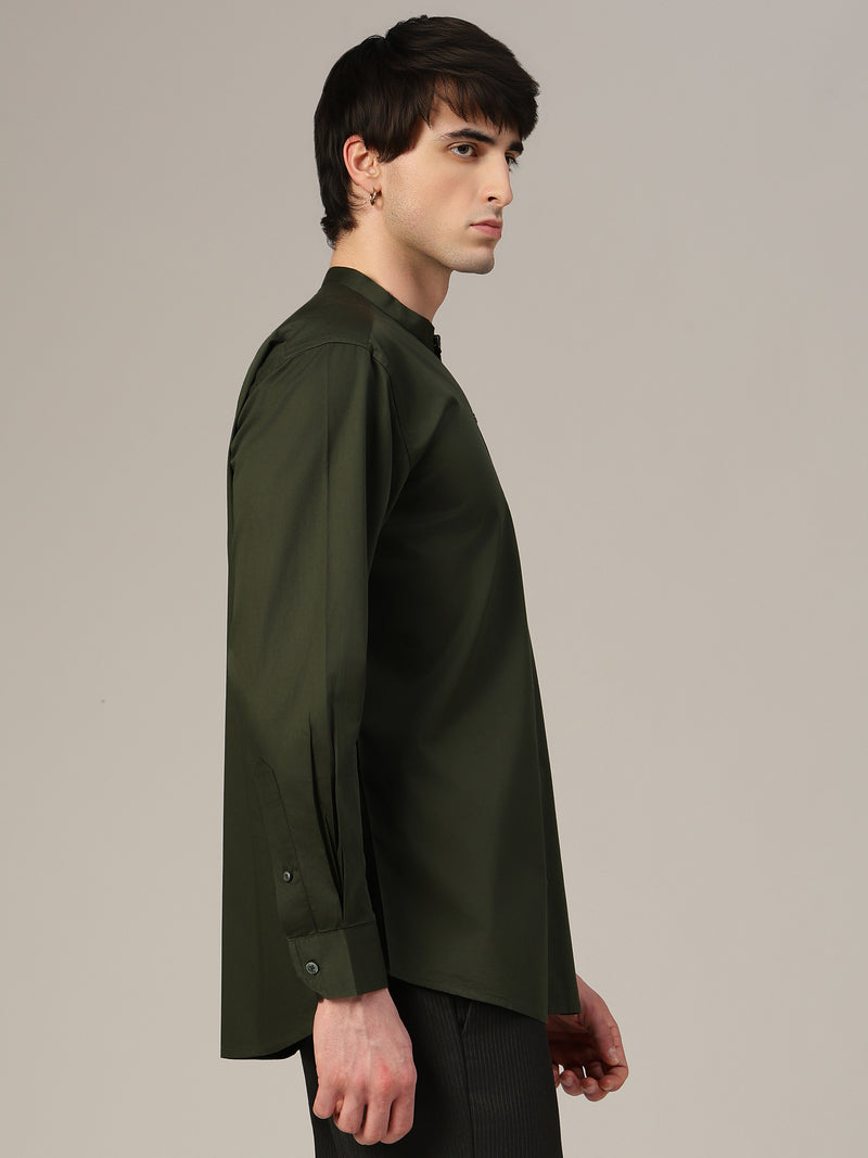 Man wearing a dark green shirt against a plain background