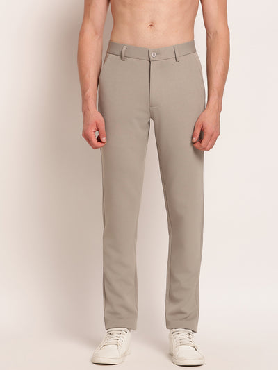 Man wearing beige pants on a plain background