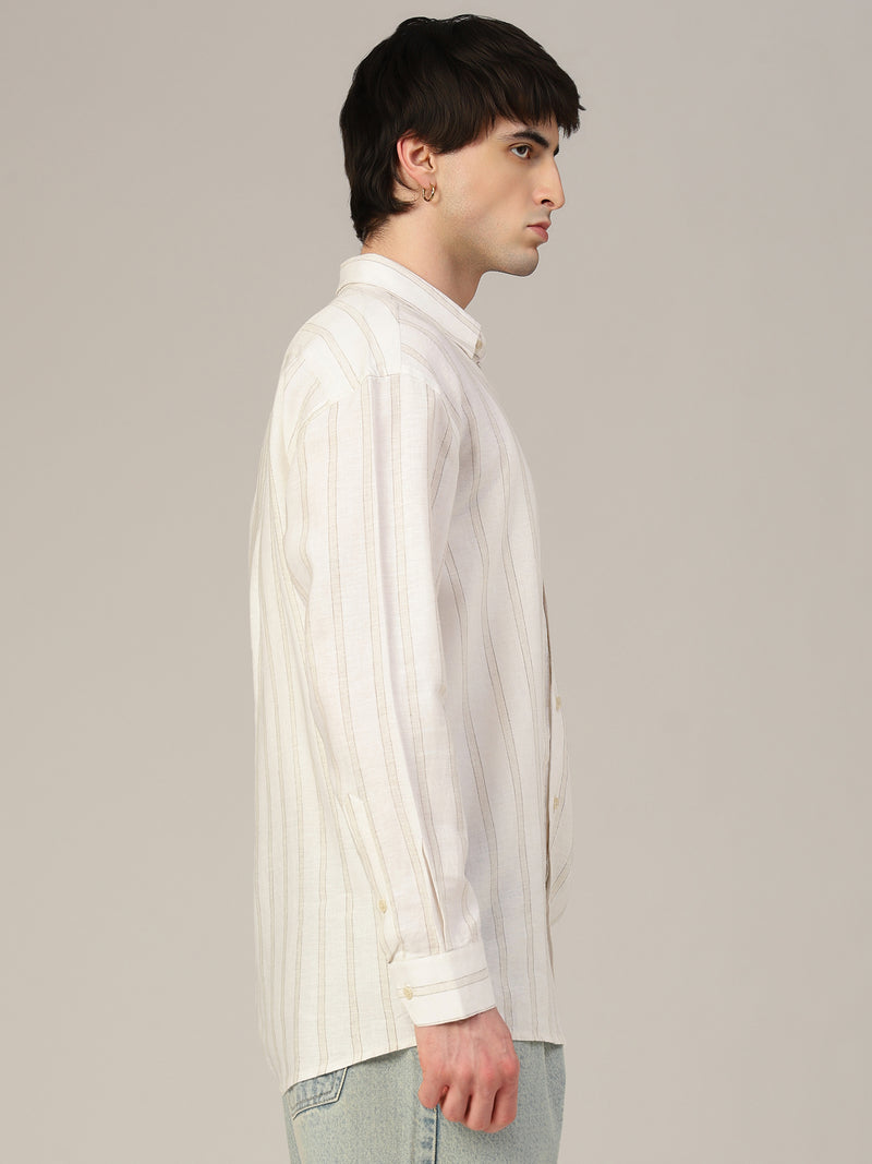 Man wearing a white striped shirt against a plain background